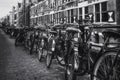 Bikes parked against the railing of the canal Oudezijds Kolk Royalty Free Stock Photo